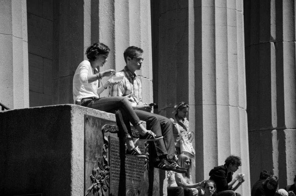 people eating lunch outside on wall street