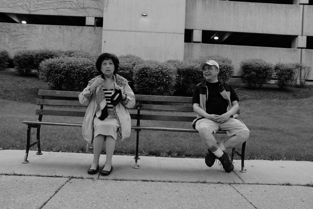 mom and dad sitting on a bench on lake shore drive